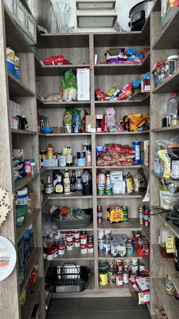 Cluttered pantry with overcrowded shelves and disorganized food items