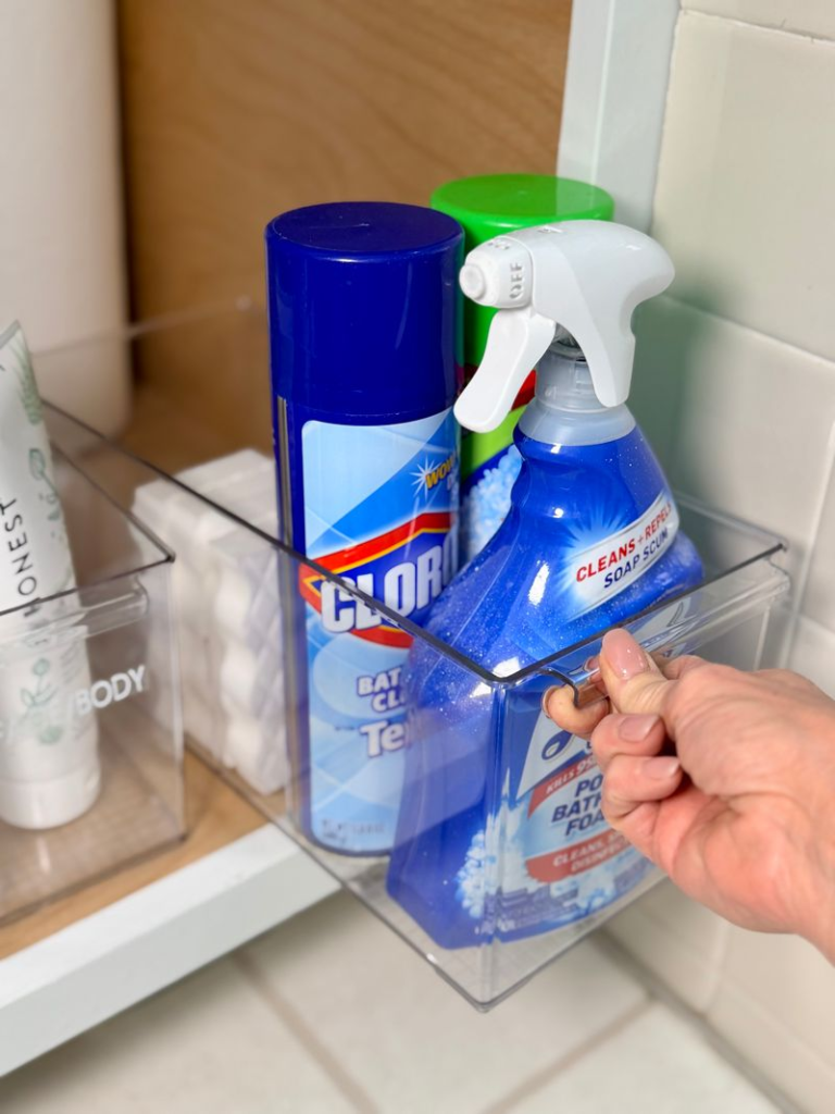 Bathroom organization ideas - Home Organization Under-sink storage bin holding bathroom cleaning supplies, including spray bottles and disinfecting products