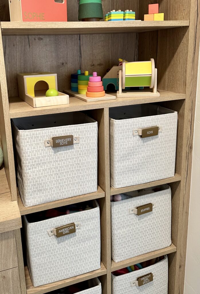 kids bedroom organization - Kids bedroom organization Wood shelving with fabric bins and small toys organized into cubbies for a simple kids’ bedroom storage system