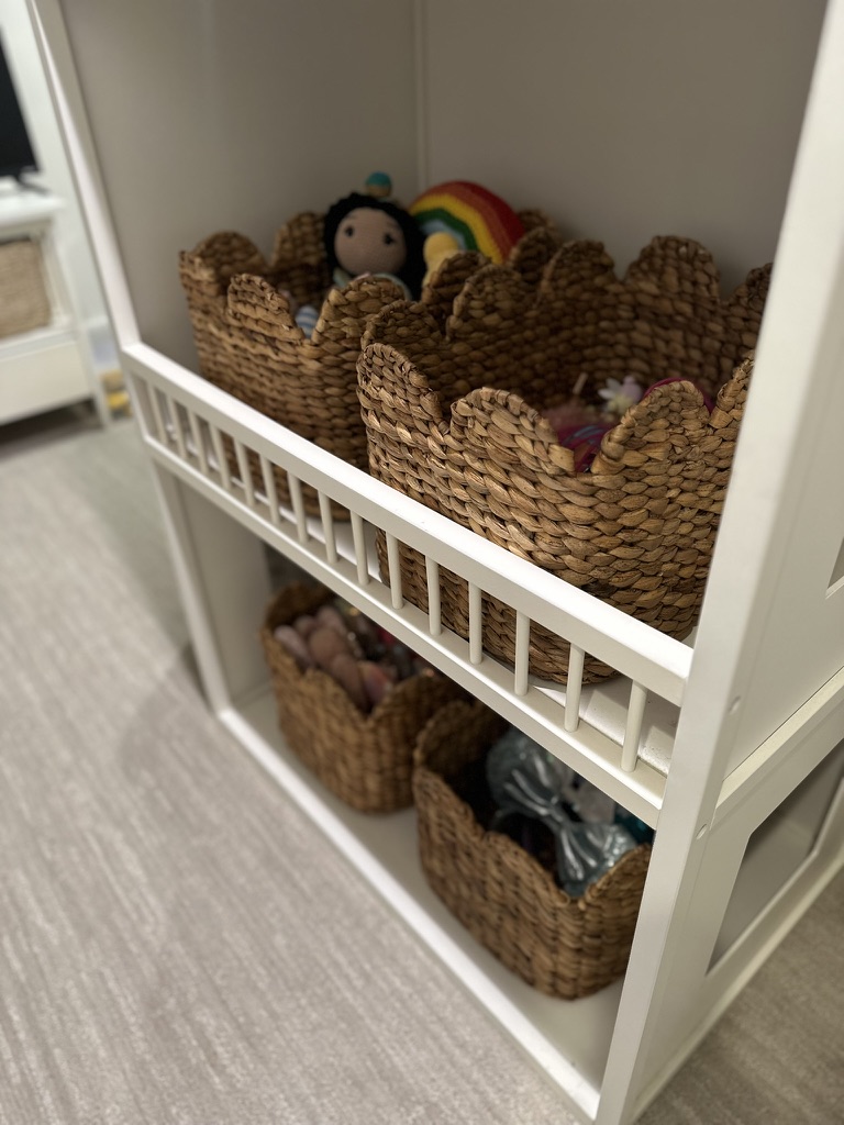 kids bedroom organization - Kids bedroom organization Woven baskets on open shelving holding toys and stuffed animals in an organized kids’ bedroom storage setup