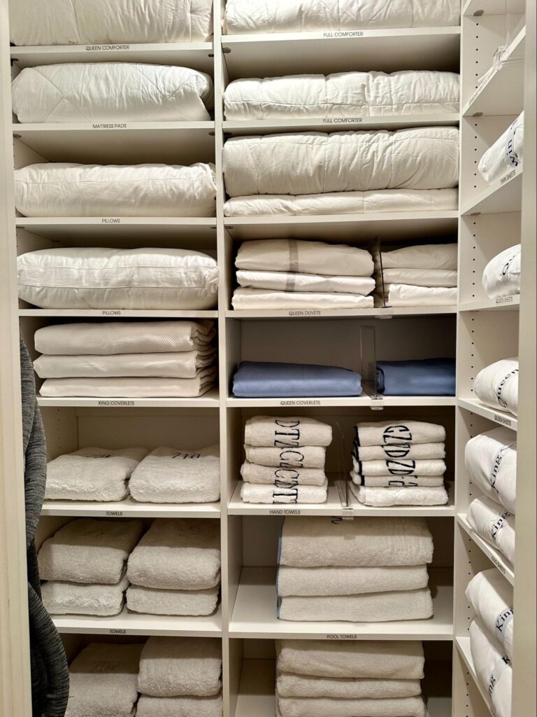 linen closet organization - Home Organization Linen closet with cubby shelves holding neatly folded towels, sheets, and bedding organized by category