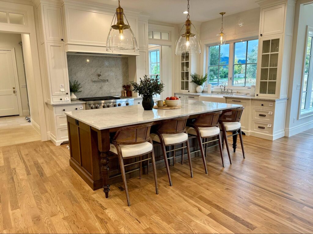 Spring cleaning checklist - Home Organization Bright modern kitchen with large island, bar stools, pendant lighting, and clean countertops