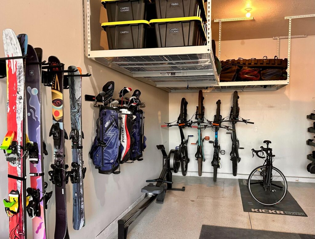 Garage wall storage system with bikes, skis, and gear organized on slat wall racks