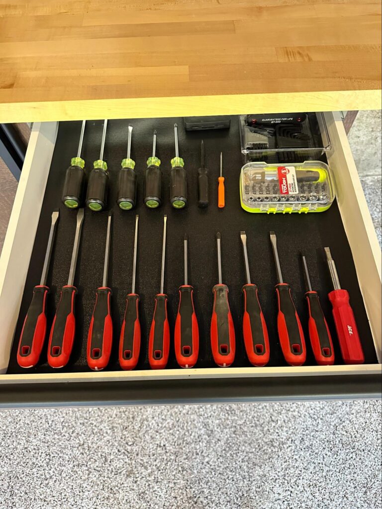 Organized drawer with screwdrivers and tool set neatly arranged