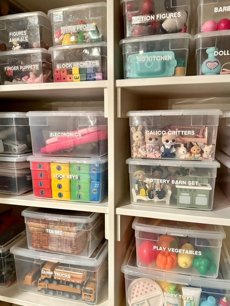 Toy rotation ideas - Kids bedroom organization Clear labeled toy bins organized on built-in shelves with dolls, pretend play toys, blocks, and activity sets.