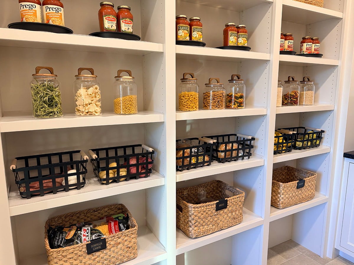 Elegant white wooden pantry shelves organized by Tracy Bowers and Organize Simply team