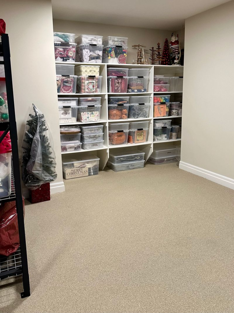 Holiday decorations grouped in labeled clear storage bins