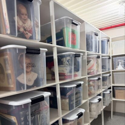 Labeled family memory bins organized on storage room shelves