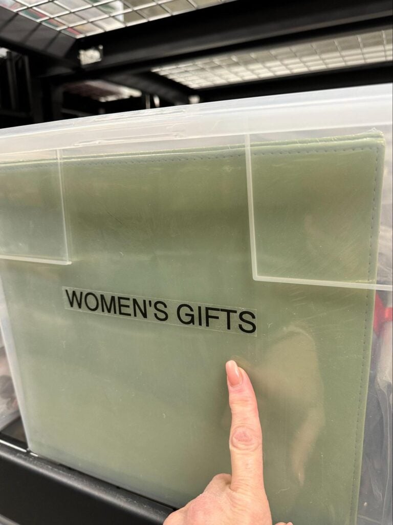 Clear storage bin labeled Women's Gifts with easy-to-read label