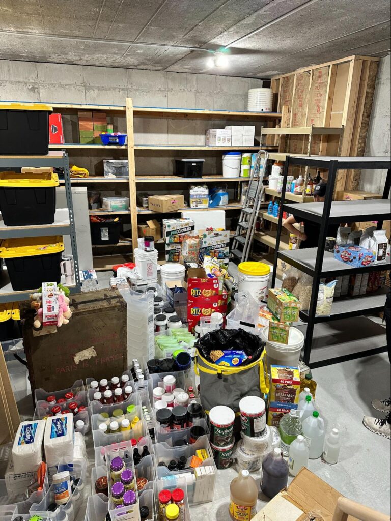 Unfinished basement with household supplies spread across the floor during a decluttering and organization project.