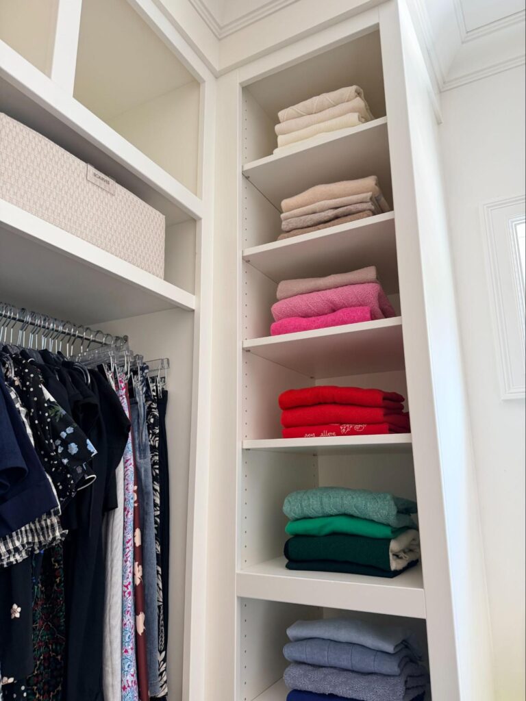 walk in closet organization - Closet Organization White walk-in closet shelving with neatly folded clothing organized by color alongside hanging garments.