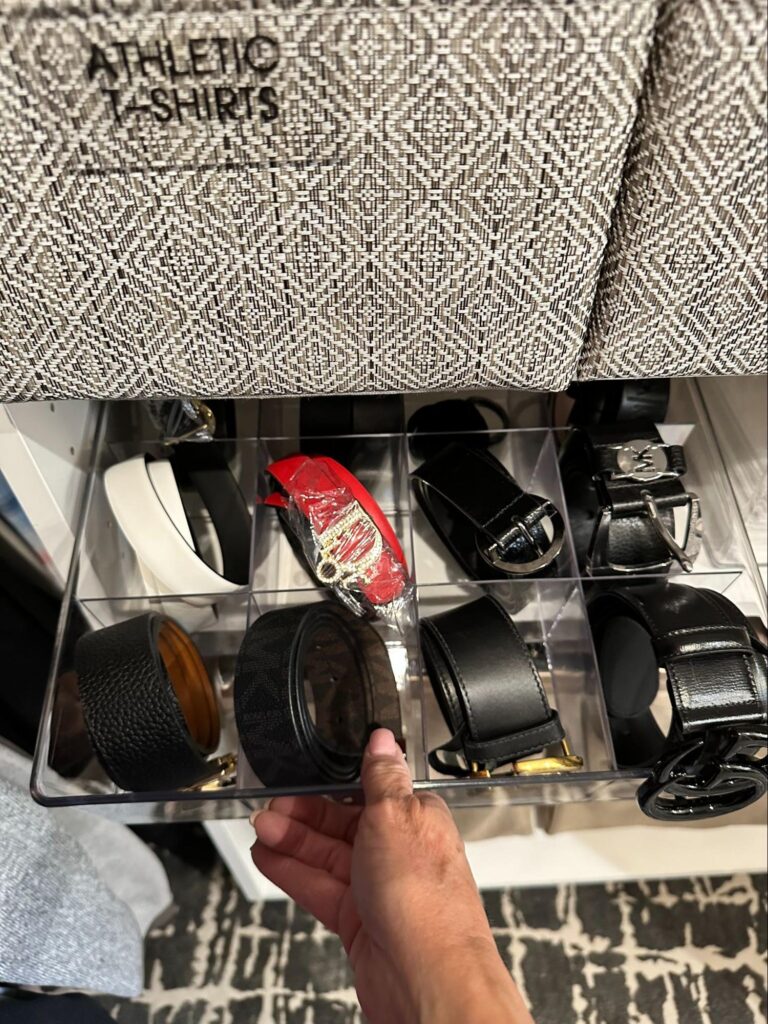 walk in closet organization - Closet Organization Clear acrylic drawer organizer with individual compartments holding neatly rolled men's belts.