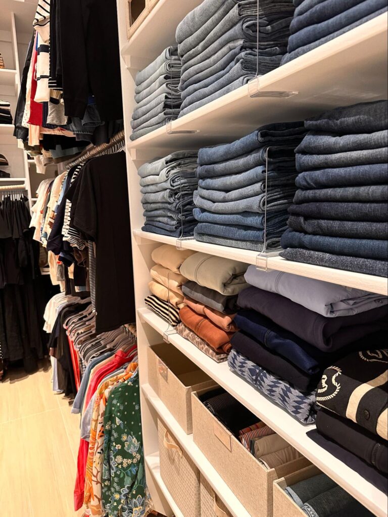 walk in closet organization - Closet Organization Walk-in closet shelving with neatly folded stacks of jeans, sweaters, and pants organized using shelf dividers.