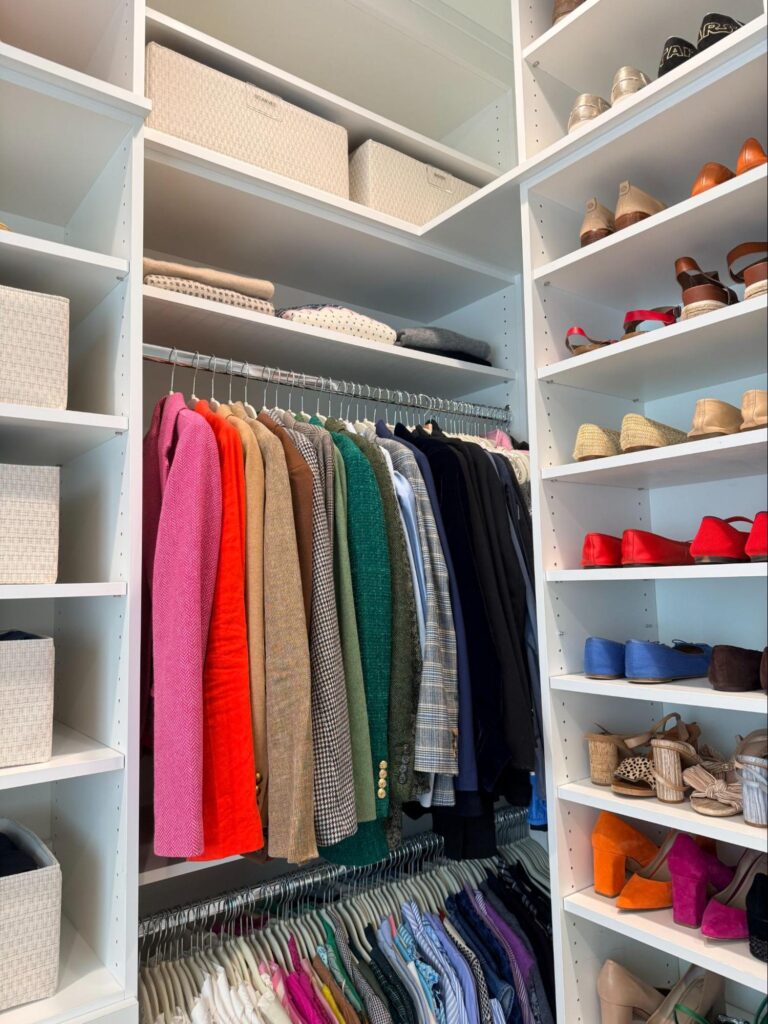 walk in closet organization - Closet Organization Organized walk-in closet with white built-in shelving, color-coded hanging clothes, shoe displays, and storage baskets.
